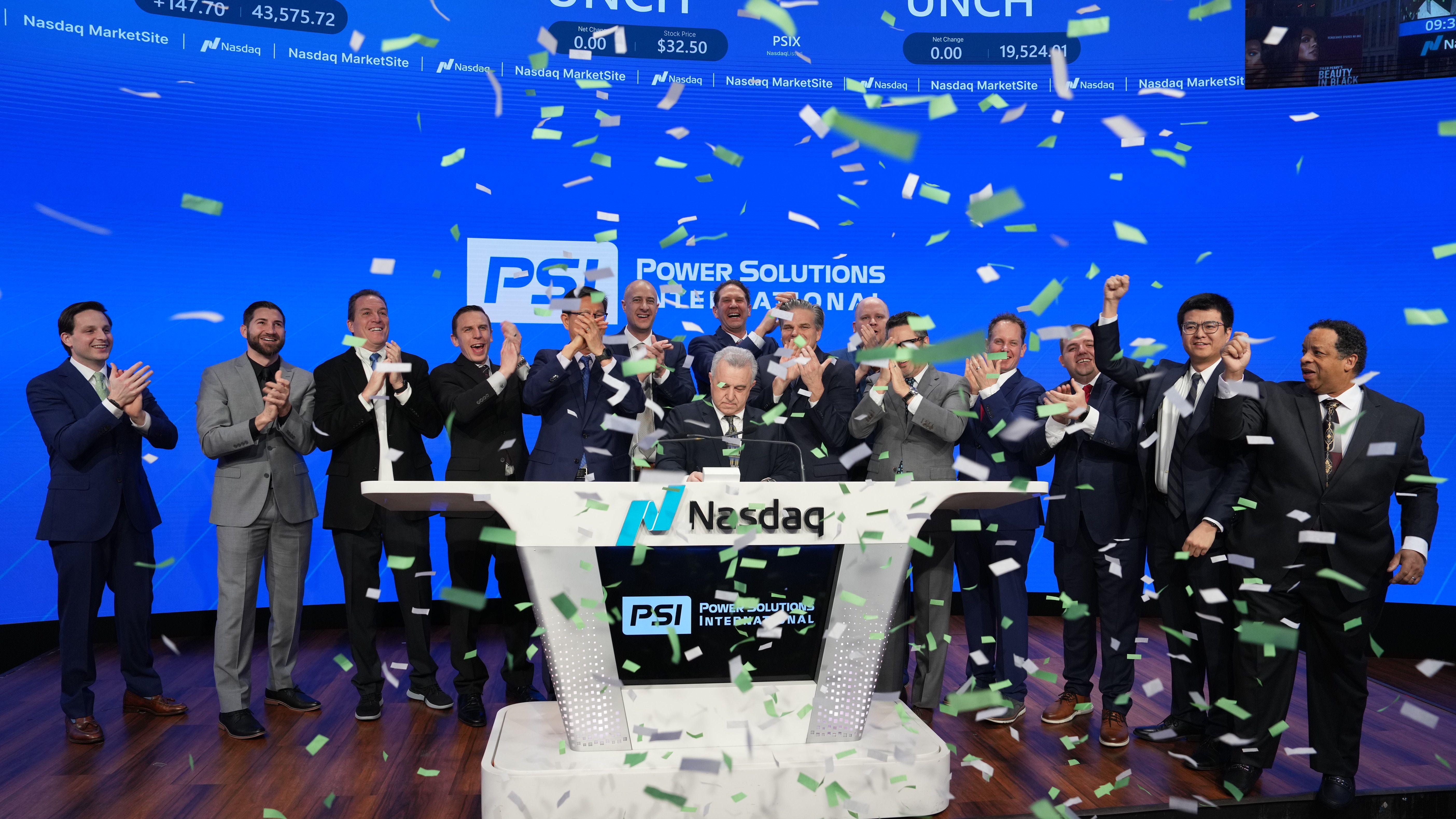 PSI leadership and Nasdaq officials commemorate the company's achievements on the trading floor.